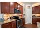 Modern kitchen features stainless steel appliances and granite countertops at 9660 Godwin St, Ladson, SC 29456