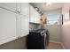 Convenient laundry room with modern washer/dryer and upper cabinet storage at 9660 Godwin St, Ladson, SC 29456