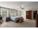 Large bedroom with a ceiling fan, windows, and closet access at 9660 Godwin St, Ladson, SC 29456