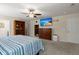 Spacious main bedroom with a ceiling fan, shelving, and large screen television at 9660 Godwin St, Ladson, SC 29456