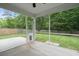 Screened-in porch with a view of the lush backyard and privacy fence at 9660 Godwin St, Ladson, SC 29456