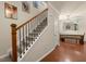 Inviting entryway featuring a carpeted staircase with wooden handrail and open dining space at 9660 Godwin St, Ladson, SC 29456