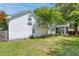Expansive backyard featuring lush green grass, mature trees, and a screened-in porch, perfect for outdoor relaxation at 99 Shadowmoss Pkwy, Charleston, SC 29414