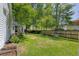 Large, well-maintained backyard with a green lawn, surrounded by mature trees and a wooden fence for privacy at 99 Shadowmoss Pkwy, Charleston, SC 29414