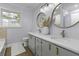 Bathroom featuring double sinks, sleek vanities, and modern fixtures, illuminated by natural light at 99 Shadowmoss Pkwy, Charleston, SC 29414