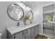 Bathroom featuring double sinks, sleek vanities, and modern fixtures, illuminated by natural light at 99 Shadowmoss Pkwy, Charleston, SC 29414