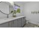 Bright bathroom with grey vanity, a large round mirror, and views to the outdoors at 99 Shadowmoss Pkwy, Charleston, SC 29414
