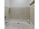 A luxurious bathtub with tiled walls and a relaxing atmosphere, with a candle nearby at 99 Shadowmoss Pkwy, Charleston, SC 29414
