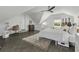 Bright bedroom with a desk area, sloped ceiling, whitewashed walls, guitars, and a patterned rug at 99 Shadowmoss Pkwy, Charleston, SC 29414
