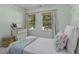 Charming bedroom featuring pineapple-themed wallpaper, two windows with blinds, and a comfy bed at 99 Shadowmoss Pkwy, Charleston, SC 29414