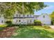 Charming two-story home with a covered front porch, well-manicured lawn, and mature landscaping at 99 Shadowmoss Pkwy, Charleston, SC 29414