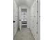 Hallway with white cabinets and a glimpse into the bedroom with the ceiling fan at 99 Shadowmoss Pkwy, Charleston, SC 29414