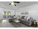 Spacious living room with comfortable sectional sofa, marble top coffee table, and access to outdoor patio at 99 Shadowmoss Pkwy, Charleston, SC 29414