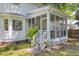 Charming screened porch with stairs, complemented by elegant landscaping and a view of the backyard at 99 Shadowmoss Pkwy, Charleston, SC 29414
