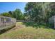 Large, green backyard featuring a wooden deck, mature trees, and a well-maintained lawn at 101 N Warwick Trce, Goose Creek, SC 29445
