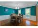 Dining room with hardwood floors, two windows, stylish pendant lighting and teal accent wall at 101 N Warwick Trce, Goose Creek, SC 29445