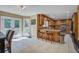 Bright kitchen boasts wood cabinets, granite countertops, breakfast bar with stools and double glass doors to outdoor area at 101 N Warwick Trce, Goose Creek, SC 29445