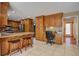 Spacious kitchen with granite countertops, wood cabinets, stainless steel appliances, and breakfast bar with stools at 101 N Warwick Trce, Goose Creek, SC 29445