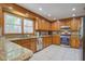 Well-equipped kitchen features granite countertops, tiled backsplash, stainless steel appliances and ample wood cabinets at 101 N Warwick Trce, Goose Creek, SC 29445