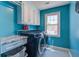 Bright laundry room with modern washer and dryer units, white cabinets, and a stylish tiled floor at 101 N Warwick Trce, Goose Creek, SC 29445