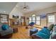 Cozy living room showcasing a brick fireplace, built-in shelving, and large windows for natural light at 101 N Warwick Trce, Goose Creek, SC 29445