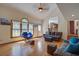 Bright living room featuring hardwood floors, a large arched window, and comfortable seating arrangements at 101 N Warwick Trce, Goose Creek, SC 29445