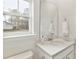 Bright half bathroom with white quartz countertops and a view of the outdoors at 1024 Sagegrass St, Summerville, SC 29485