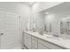 Modern bathroom featuring double sinks, quartz countertops, and a large mirror at 1024 Sagegrass St, Summerville, SC 29485