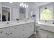 Bright bathroom featuring a double vanity, soaking tub, and tiled floors for a modern touch at 106 Pickering Ln, Charleston, SC 29414
