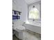 Charming bathroom showcasing a soaking tub under a window with a decorative orchid and playful frog at 106 Pickering Ln, Charleston, SC 29414