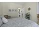 Cozy bedroom features a wood frame bed, hardwood floors, and access to a bathroom at 106 Pickering Ln, Charleston, SC 29414