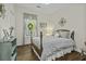 Cozy bedroom features a wood frame bed, hardwood floors, and a window with natural light at 106 Pickering Ln, Charleston, SC 29414
