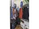 Organized walk-in closet with hanging clothes, storage bins, and bags for optimal storage at 106 Pickering Ln, Charleston, SC 29414
