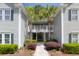 Inviting condo entrance with lush landscaping and tropical palm trees framing the walkway at 106 Pickering Ln, Charleston, SC 29414