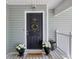 Charming front door with a floral wreath, potted plants, and a welcoming 'HOME' doormat at 106 Pickering Ln, Charleston, SC 29414