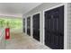 Hallway with a row of black doors, and outdoor wooded views at 106 Pickering Ln, Charleston, SC 29414
