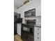 Updated kitchen featuring black appliances, granite counters, white cabinets, and mosaic backsplash at 106 Pickering Ln, Charleston, SC 29414