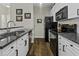Updated kitchen featuring stainless sink, black appliances, granite counters, and white cabinets at 106 Pickering Ln, Charleston, SC 29414