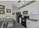 Updated kitchen featuring granite counters, modern appliances, white cabinets, and mosaic backsplash at 106 Pickering Ln, Charleston, SC 29414