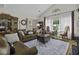 Inviting living room featuring hardwood floors, vaulted ceilings, and a comfortable brown leather sofa at 106 Pickering Ln, Charleston, SC 29414