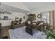 Open-concept living room and dining area with hardwood floors and comfortable brown leather sofas at 106 Pickering Ln, Charleston, SC 29414