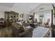 Inviting living room features hardwood floors, vaulted ceilings, and a comfortable brown leather sofa at 106 Pickering Ln, Charleston, SC 29414