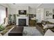 Comfortable living room with a fireplace, leather sofa, and hardwood floors at 106 Pickering Ln, Charleston, SC 29414