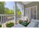 Inviting porch with white seating, green carpet, and a lovely view of surrounding greenery at 106 Pickering Ln, Charleston, SC 29414