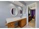 Stylish bathroom vanity with sink, mirrors, and a view into the main bedroom at 109 E Hartwick Ln, Goose Creek, SC 29445