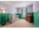 The Bedroom has playful green and purple walls, a crib, and a dresser at 109 E Hartwick Ln, Goose Creek, SC 29445