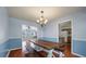Charming dining room with a rustic table, bench seating, and hardwood floors creating an inviting space at 109 E Hartwick Ln, Goose Creek, SC 29445