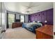 Comfortable bedroom with blue walls, large windows, and a celestial purple accent wall at 109 E Hartwick Ln, Goose Creek, SC 29445