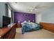 Comfortable carpeted bedroom with a celestial decorated purple accent wall and ceiling fan at 109 E Hartwick Ln, Goose Creek, SC 29445