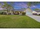 Charming single-story home featuring a covered porch, lush lawn, attached garage, and inviting curb appeal at 109 Red Cypress Dr, Goose Creek, SC 29445